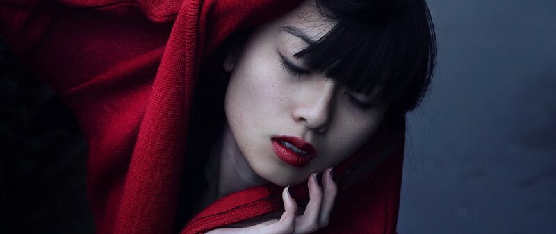 woman in red hooded garment
