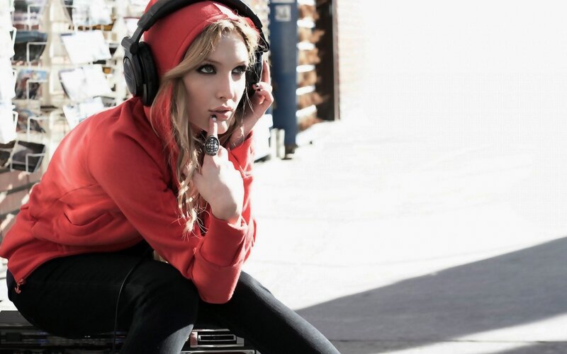 woman in red hoodie with headphones