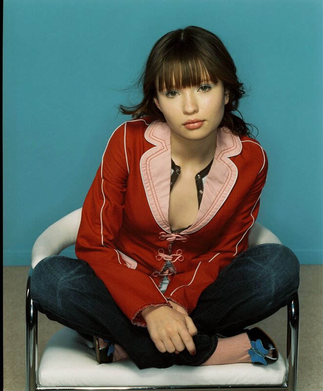 Woman in Red Jacket — Neutral, Photograph, Chair, Jeans