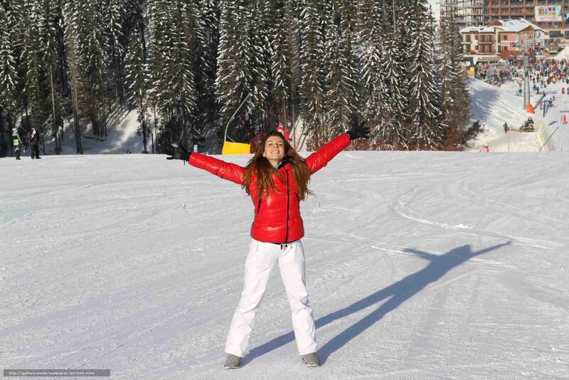woman in red jacket on ski slope