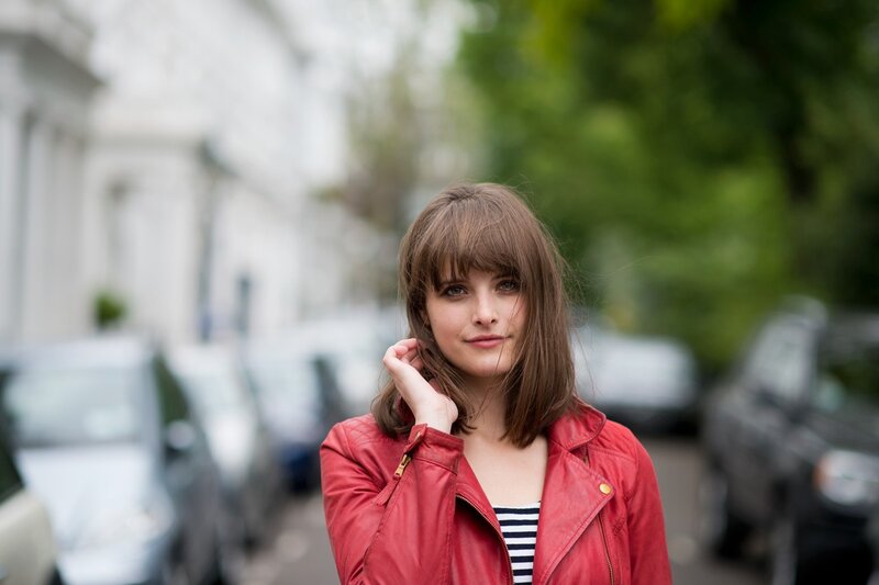 woman in red jacket on street