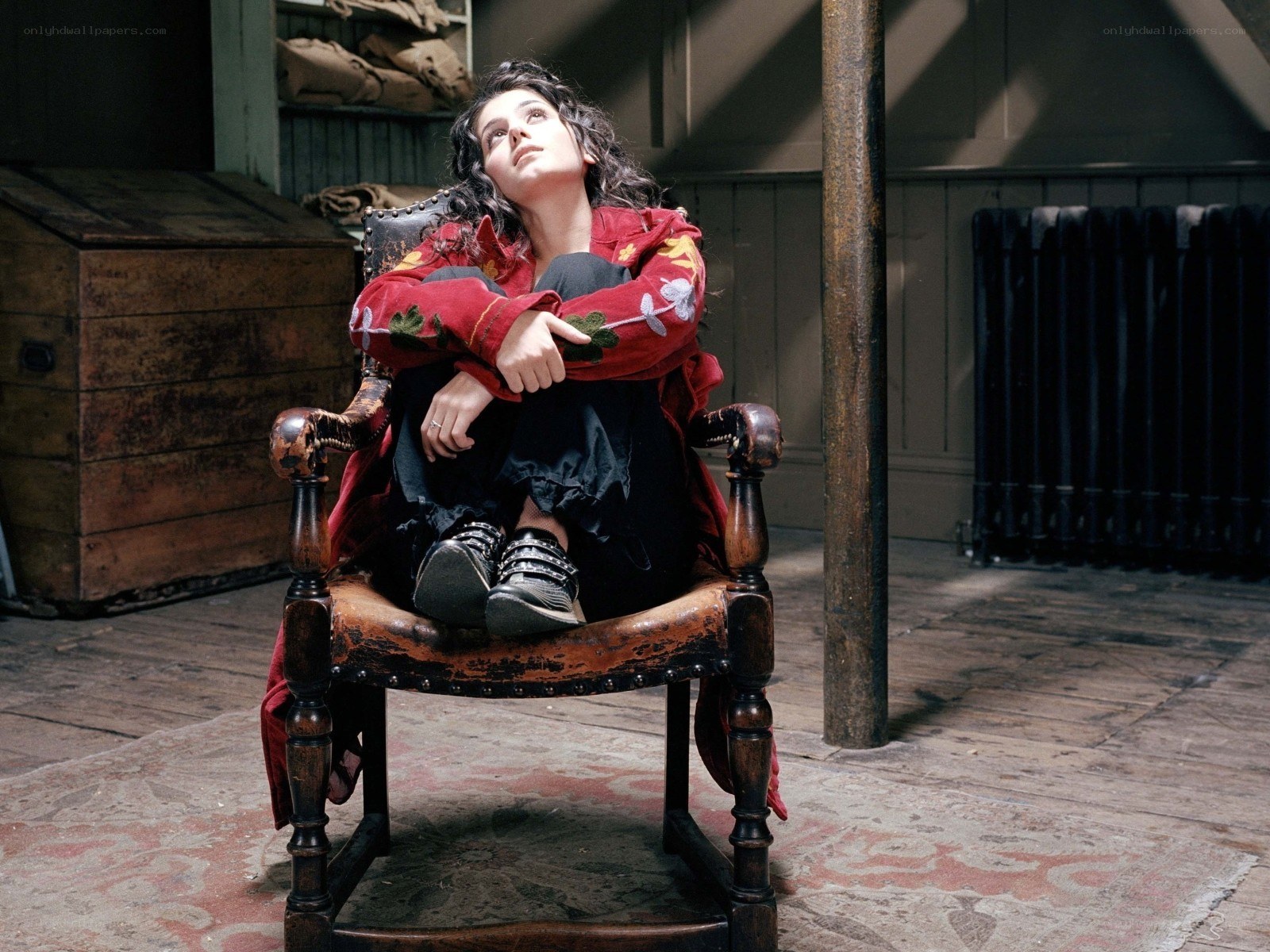 Woman in red jacket sitting