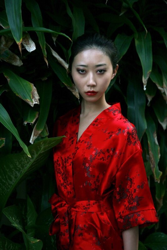 woman in red kimono among plants
