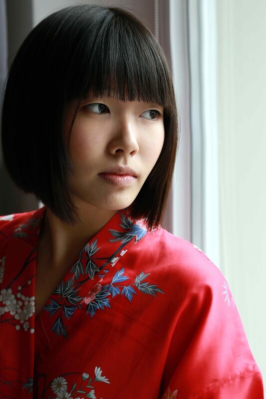 woman in red kimono by window