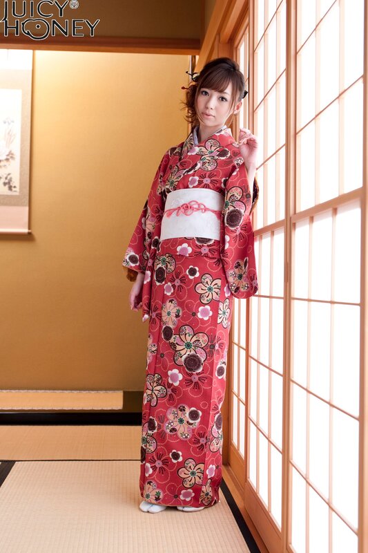 Woman in red kimono by window