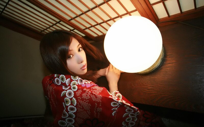 woman in red kimono holding lamp
