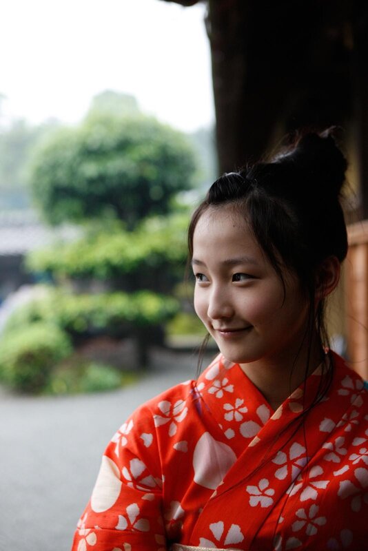 woman in red kimono smiling