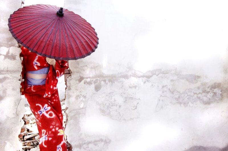 Woman in red kimono with umbrella
