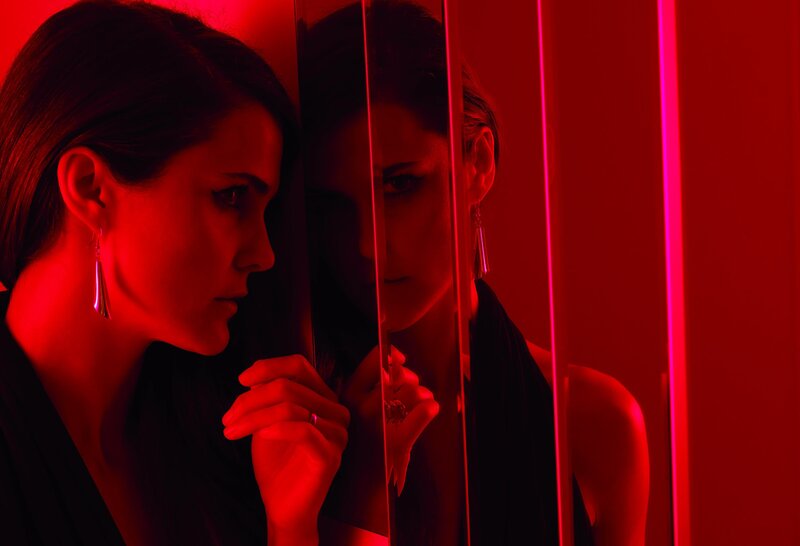 woman in red light with mirror