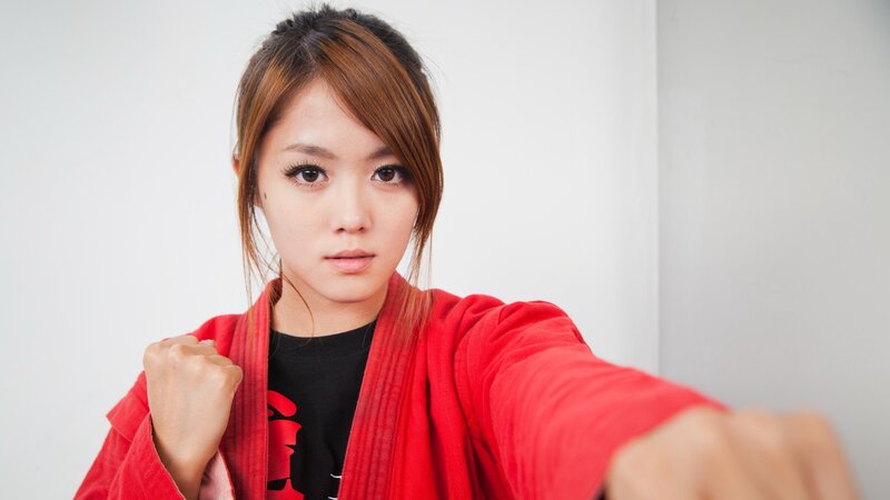 woman in red martial arts gi