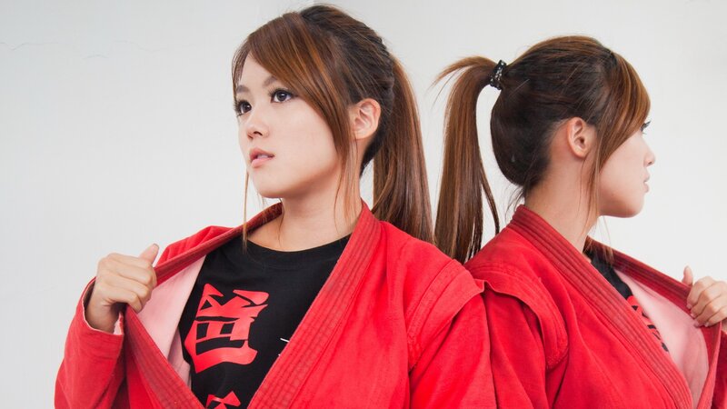 woman in red martial arts uniform