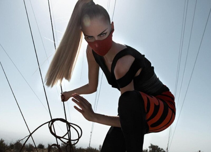woman in red mask crouching