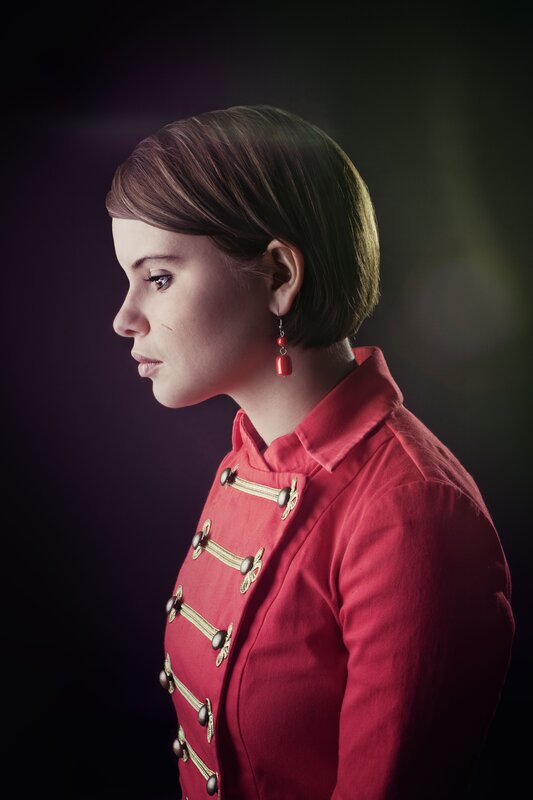 woman in red military-style jacket