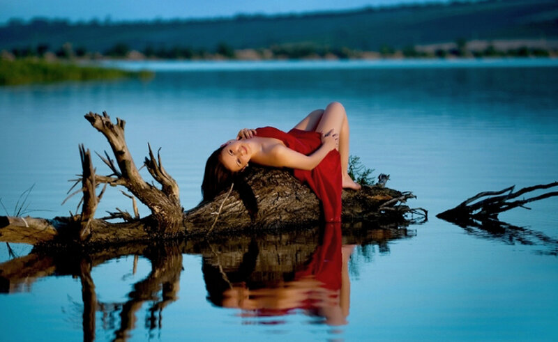 Woman in red on driftwood