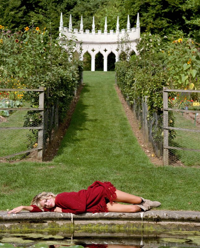 Woman in red on garden path