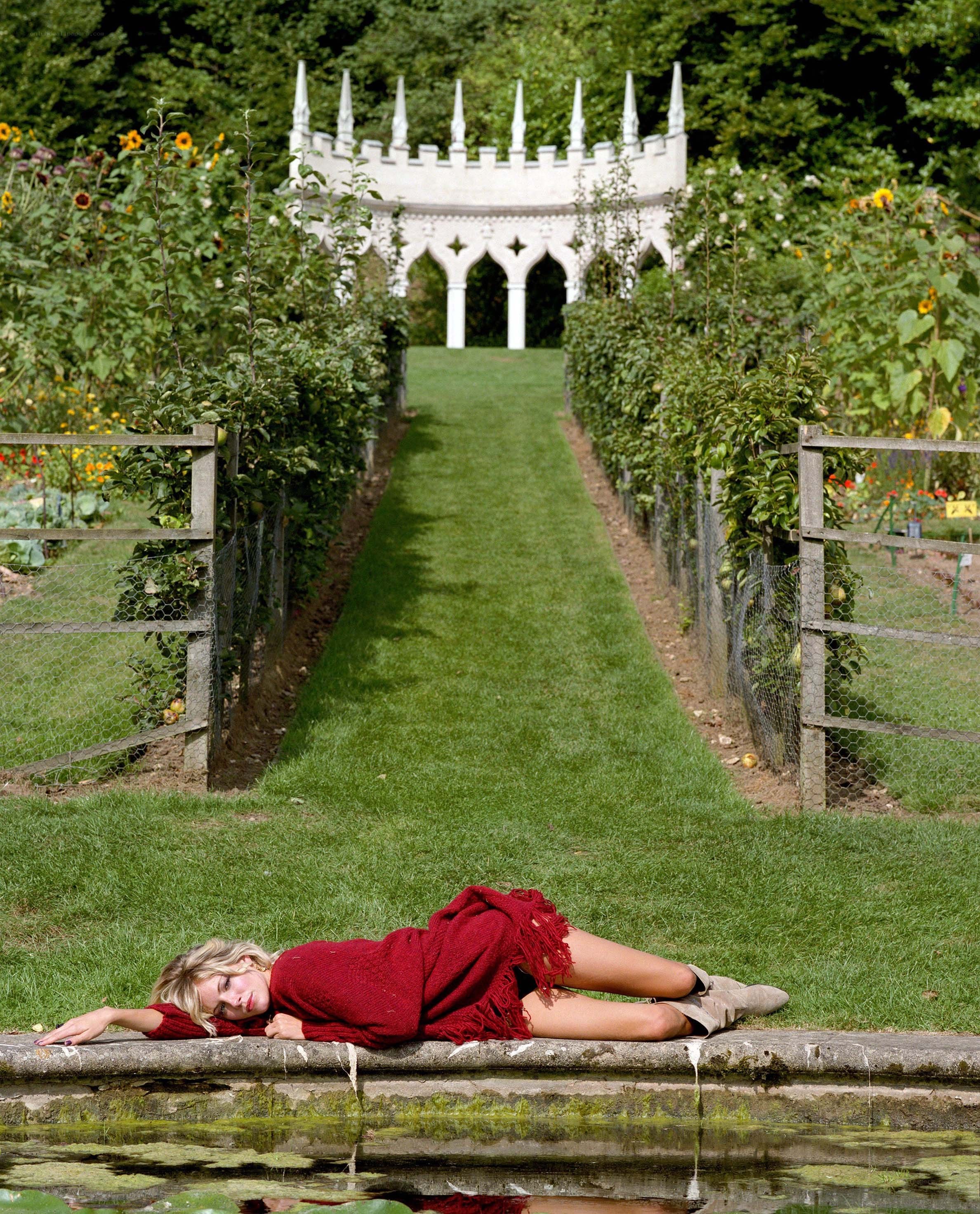 Woman in red on garden path