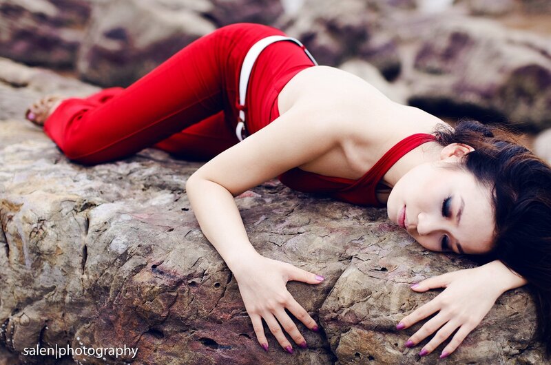 woman in red on rocky shore