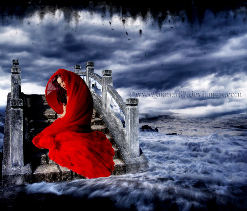 woman in red on stormy bridge