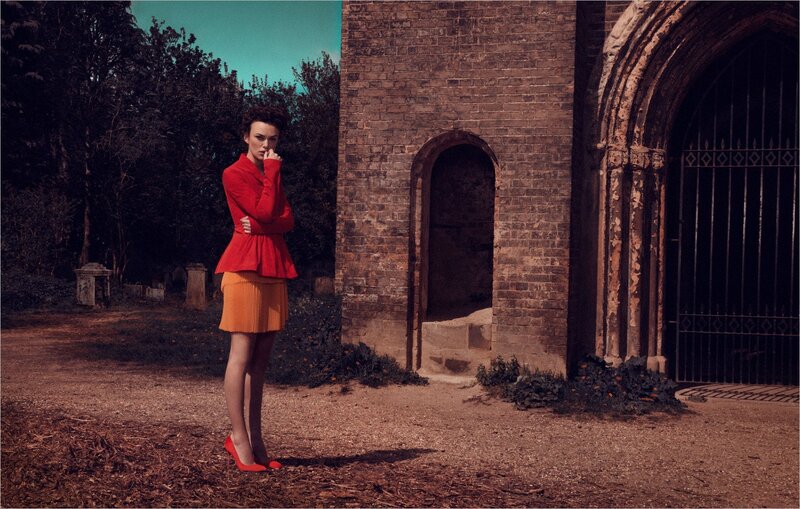 Woman in red outfit standing outside