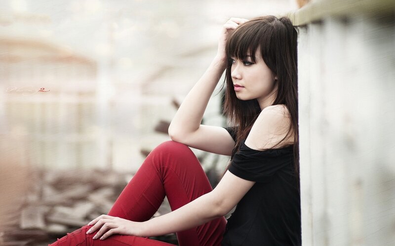 woman in red pants sitting