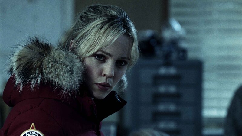 woman in red parka looking serious