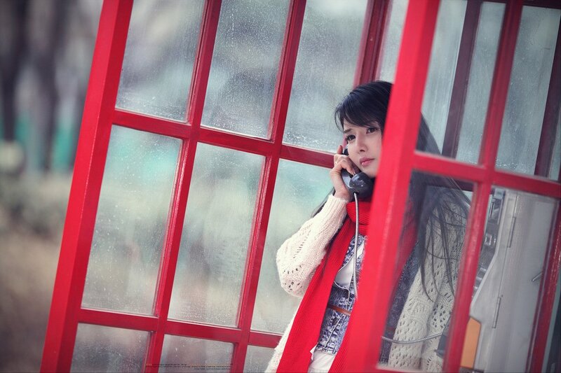woman in red phone booth