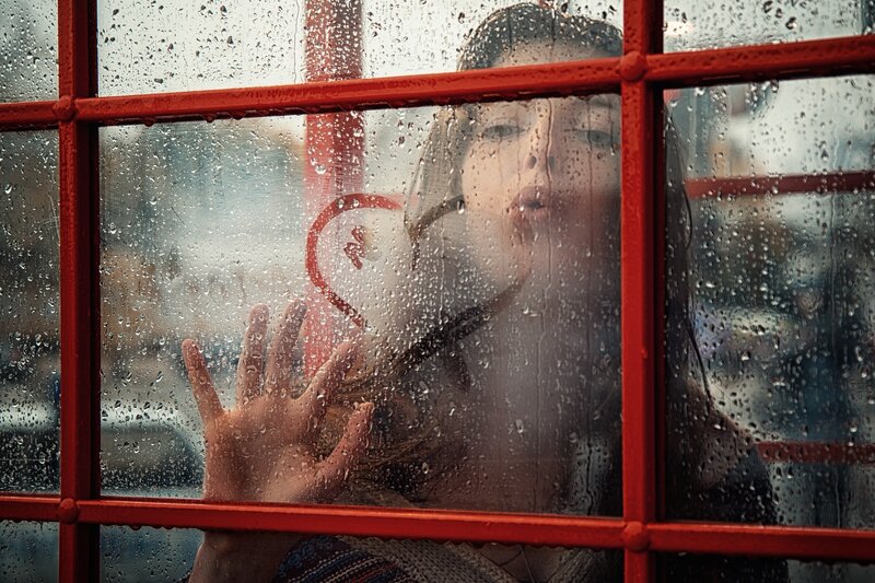 Woman in Red Phone Booth — Melancholic