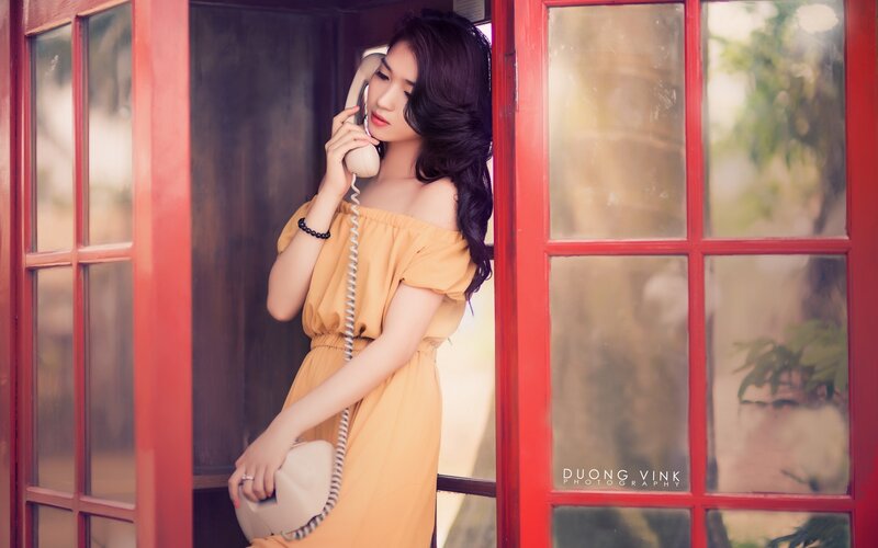Woman in red phone booth