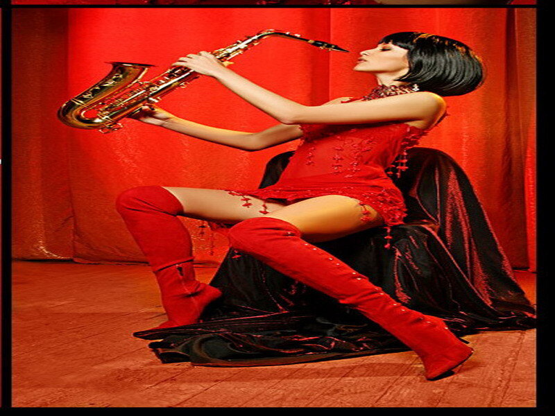 Woman in red playing saxophone