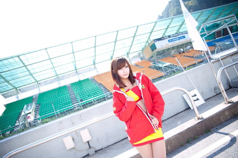Woman in red racing suit at track