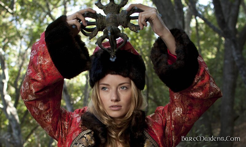 woman in red robe holding artifact