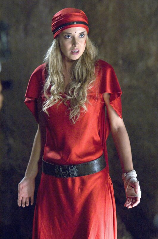 Woman in red robe with bandaged hand