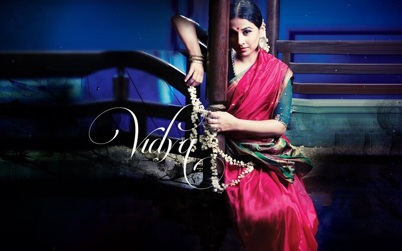 woman in red sari holding flowers