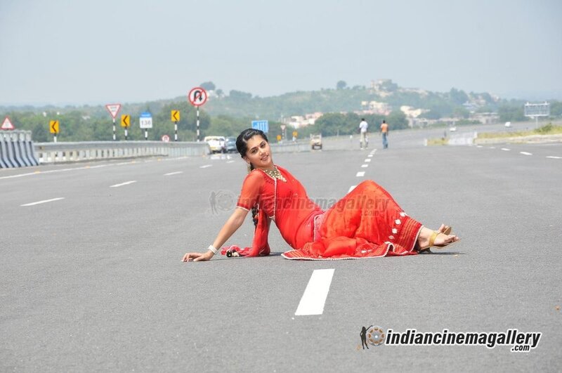 woman in red sari on road
