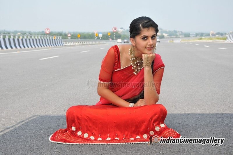 woman in red sari on road