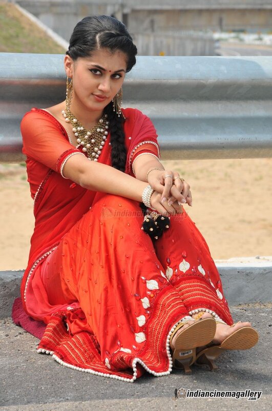 woman in red sari sitting