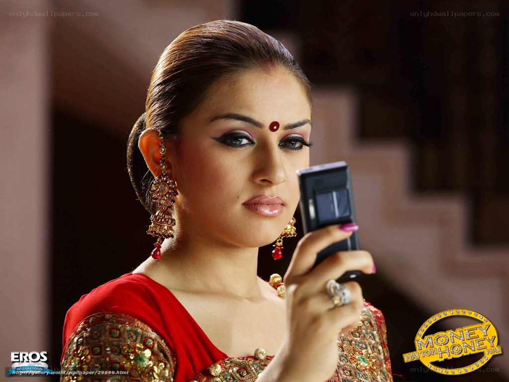 woman in red sari using phone