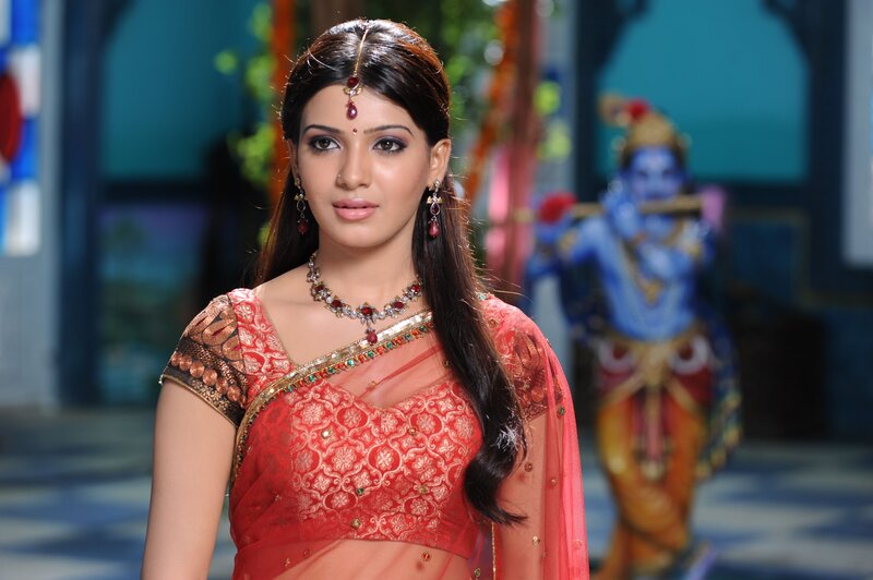woman in red sari with deity statue
