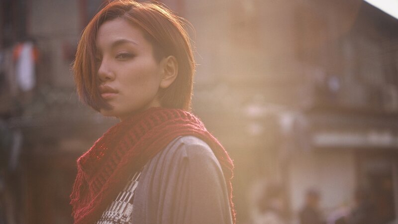 woman in red scarf at sunset