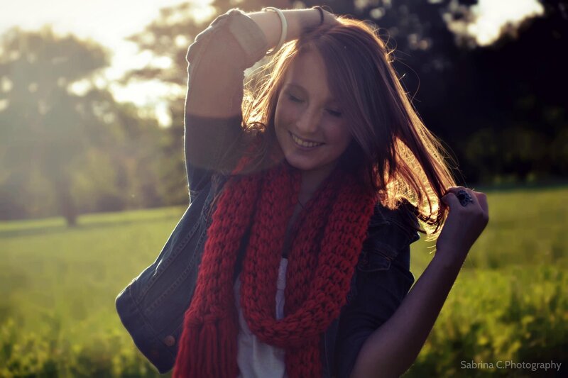 woman in red scarf at sunset