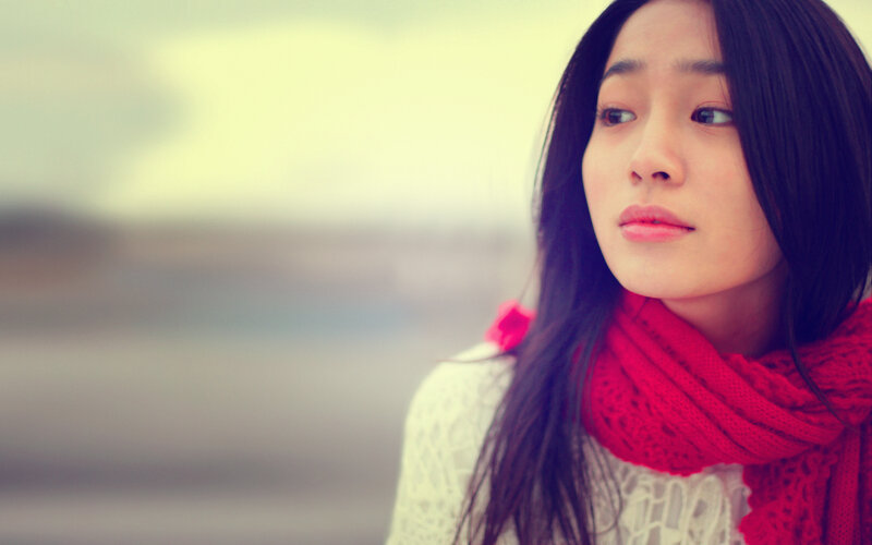 woman in red scarf looking away