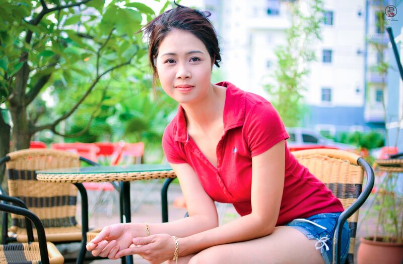 Woman in red shirt at outdoor cafe