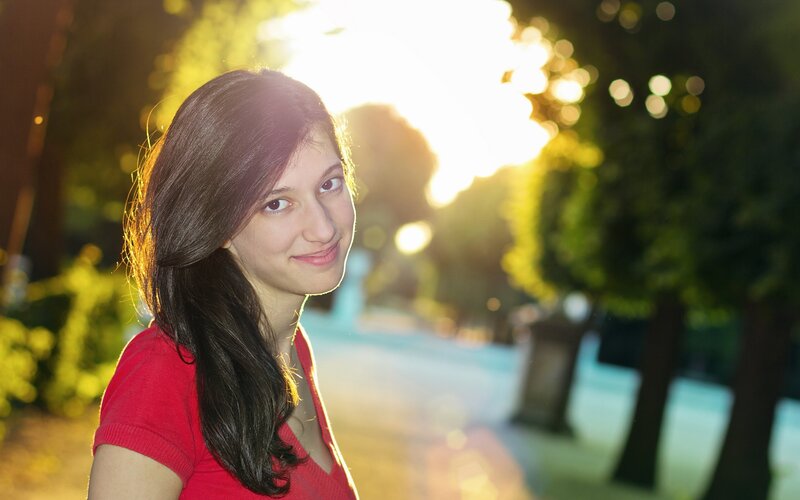 woman in red shirt at sunset