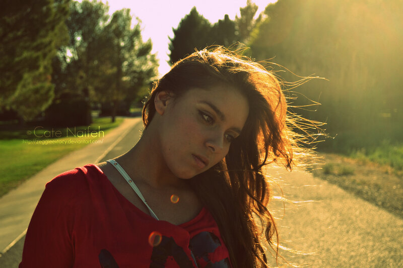 woman in red shirt at sunset