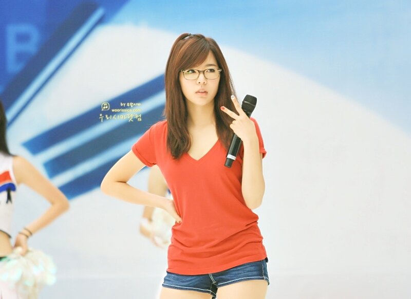 woman in red shirt holding microphone