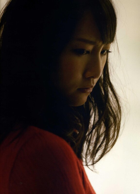 woman in red shirt looking down