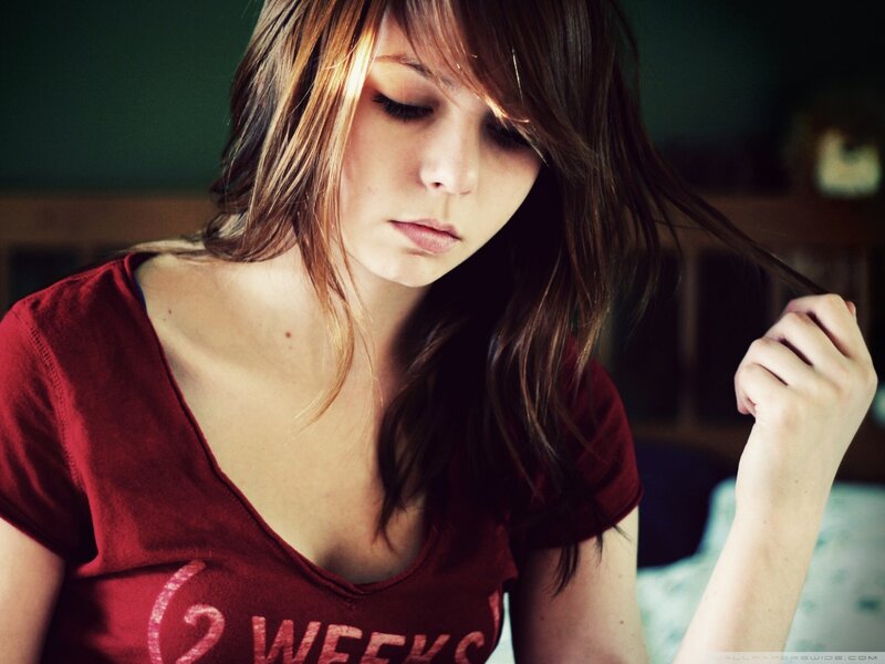 woman in red shirt looking down