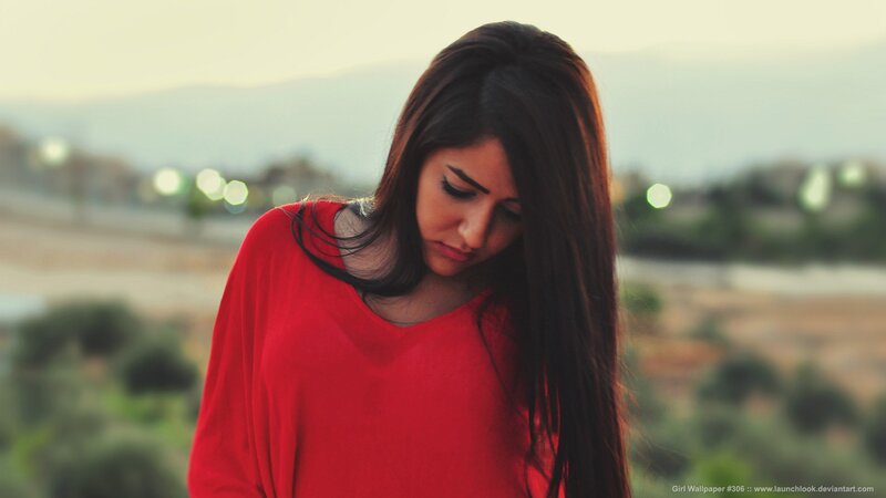 woman in red shirt looking down