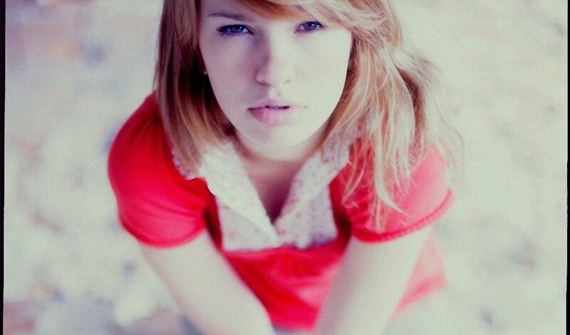 woman in red shirt looking up