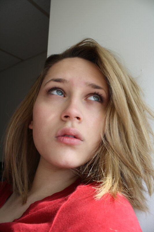 woman in red shirt looking up